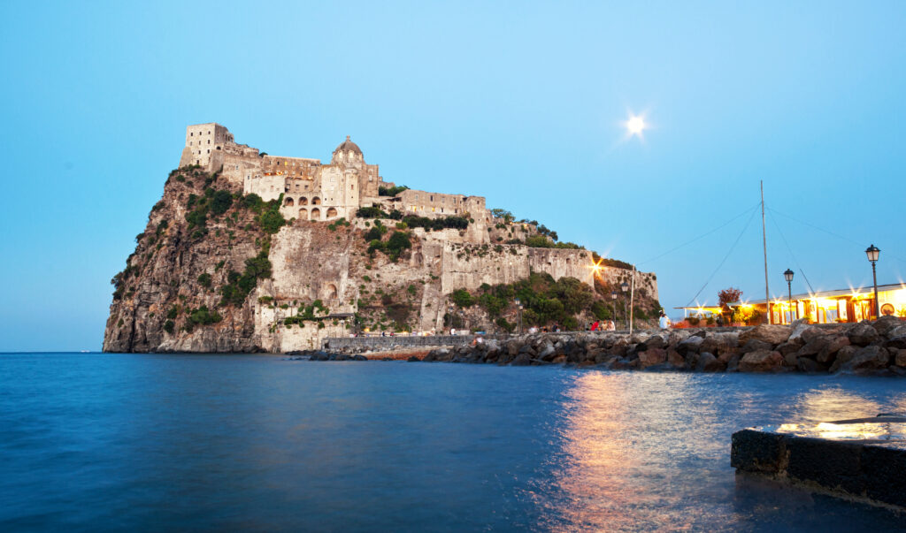 Aragonese Castle by night in Ischia island, Italy